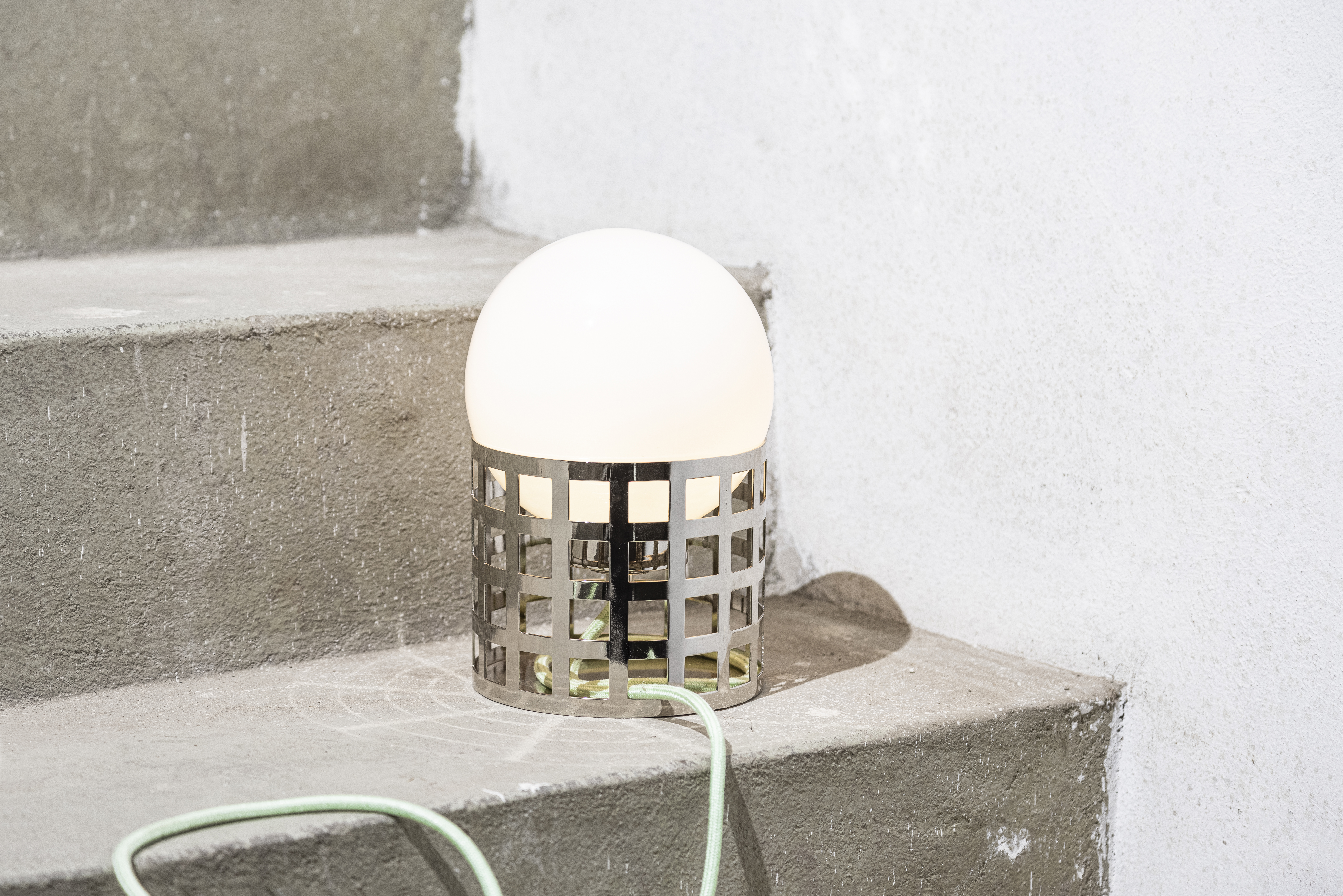 Full Moon Ride Table Lamp - Inspired by the iconic chrome finishes of the Mid Century era. Features a meticulously crafted grid pattern accentuating its geometric harmony. Conceptually alluring and transcending boundaries of conventional lighting.